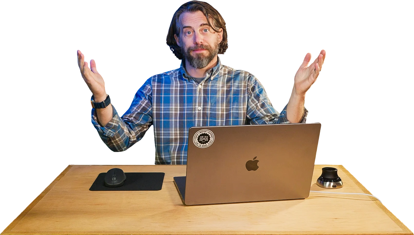 Bob Clagett at his workbench with a laptop, hands raised.